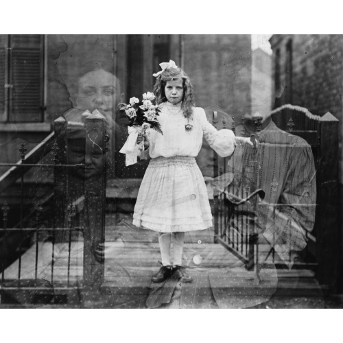 Double Exposure Spirit Photograph Of Girl Standing, Holding Flowers, Surrounded By Spectral...