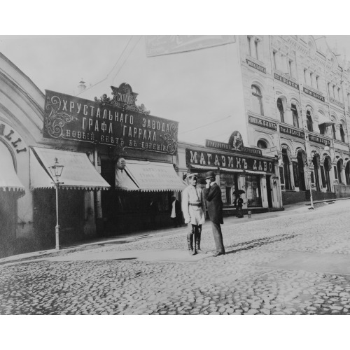 Frank Carpenter Talking To A Police Officer(?) On A Street In A Business District, Russia, circa...