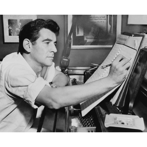 Leonard Bernstein, Half-Length Portrait, Facing Right, Seated At Piano, Making Annotations To...