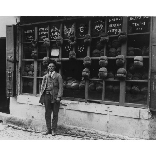 Baker Standing In Front Of The American Bakery