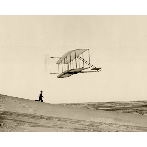 Wilbur In Glider Turning Rapidly To The Left, Dan Tate Running Alongside; Big Kill Devil Hill, 1902