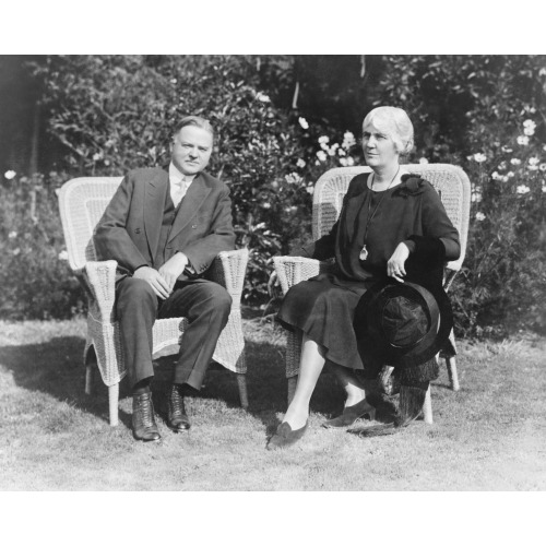 Herbert Hoover And Mrs. Hoover, Full-Length Portrait, Seated On Wicker Chairs, Facing Front, 1929
