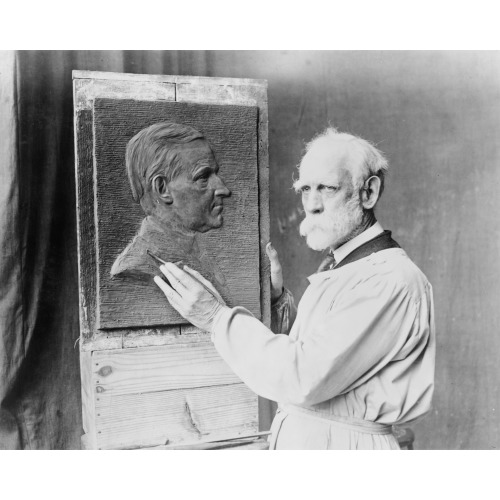 Henry K. Bush-Brown, Half-Length Portrait, Wearing Smock And Working On His Bas-Relief Portrait...