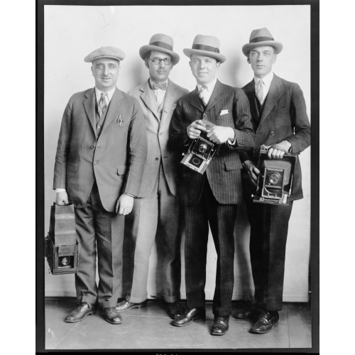 Group Portrait Of Four Members Of The White House News Photographers' Association, Standing...
