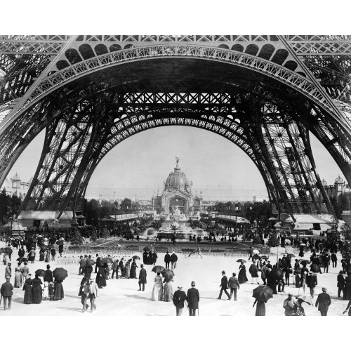 Paris Exposition, View From Ground Level Of The Eiffel Tower With Parisians Promenading, circa 1887